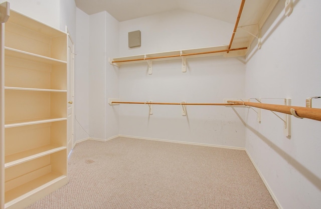 walk in closet with carpet flooring and lofted ceiling