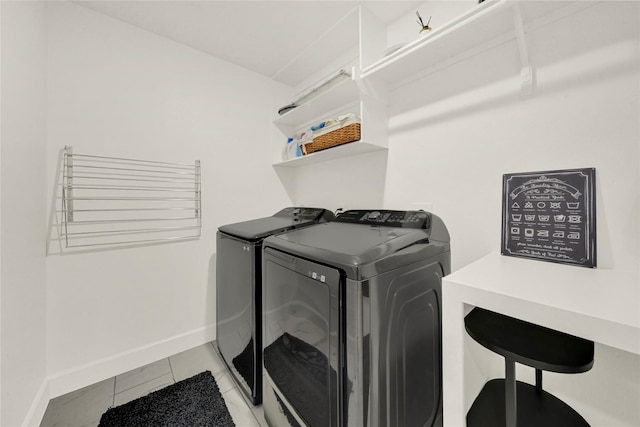 washroom featuring light tile patterned flooring and washing machine and clothes dryer