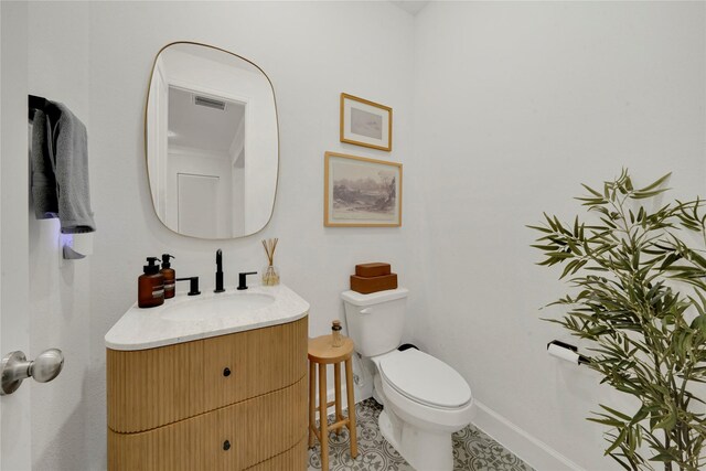 bathroom with tile patterned floors, vanity, and toilet