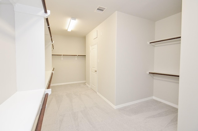 spacious closet with carpet floors and visible vents