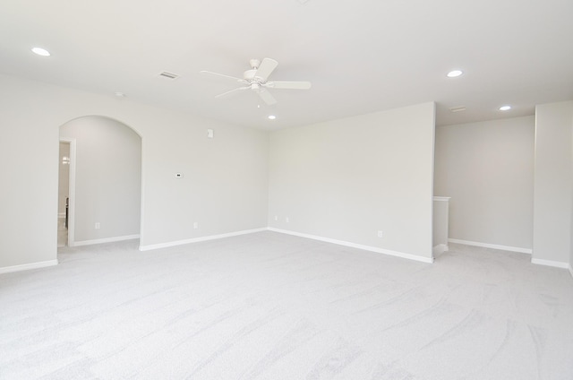 unfurnished room featuring a ceiling fan, arched walkways, baseboards, and recessed lighting