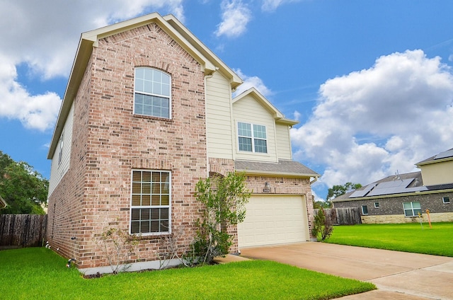 view of front of home with a front lawn and a garage