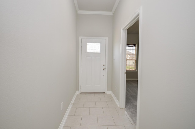 interior space with ornamental molding, light tile patterned flooring, and baseboards