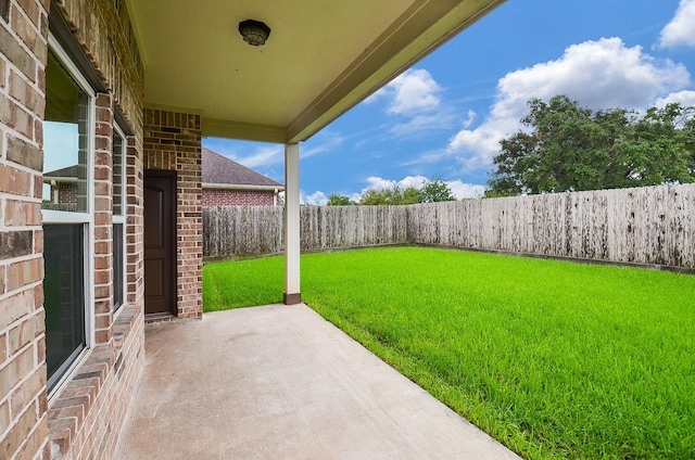 view of yard with a patio and a fenced backyard