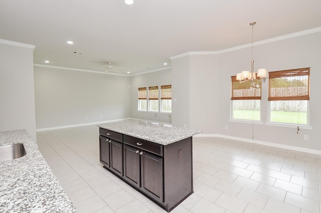 kitchen featuring open floor plan, recessed lighting, baseboards, and crown molding