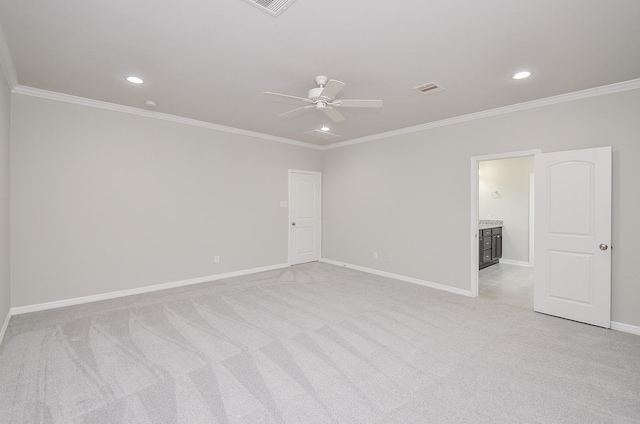 spare room featuring crown molding, recessed lighting, light colored carpet, visible vents, and baseboards