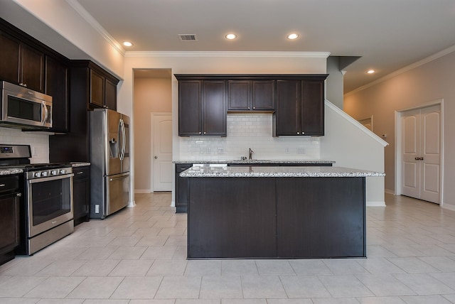 kitchen featuring stainless steel appliances, visible vents, light stone counters, and dark brown cabinets