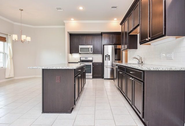 kitchen with light tile patterned flooring, visible vents, appliances with stainless steel finishes, and a center island