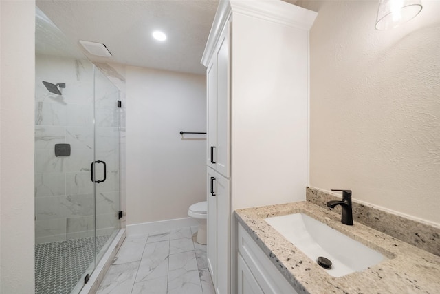 bathroom featuring an enclosed shower, vanity, and toilet