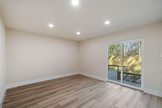 unfurnished room with light hardwood / wood-style floors