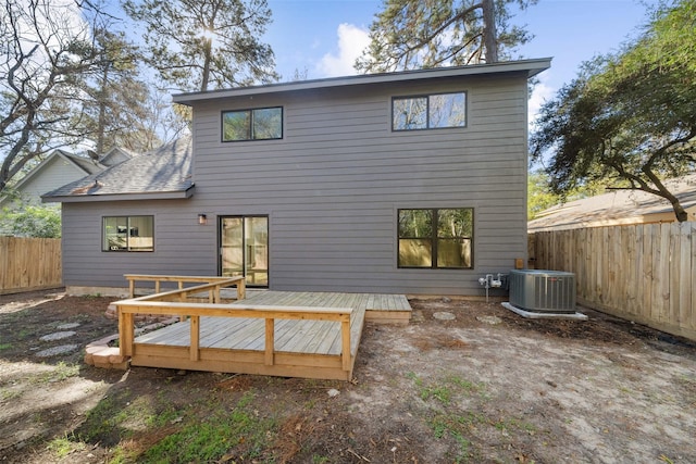 rear view of property featuring central AC and a wooden deck