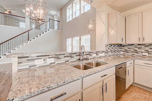 kitchen featuring pendant lighting, ceiling fan, sink, and stainless steel dishwasher