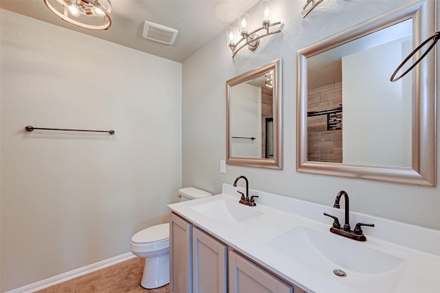 bathroom featuring tile patterned floors, vanity, and toilet