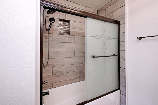 bathroom featuring combined bath / shower with glass door