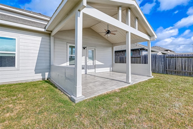 exterior space with ceiling fan, a patio area, and a yard