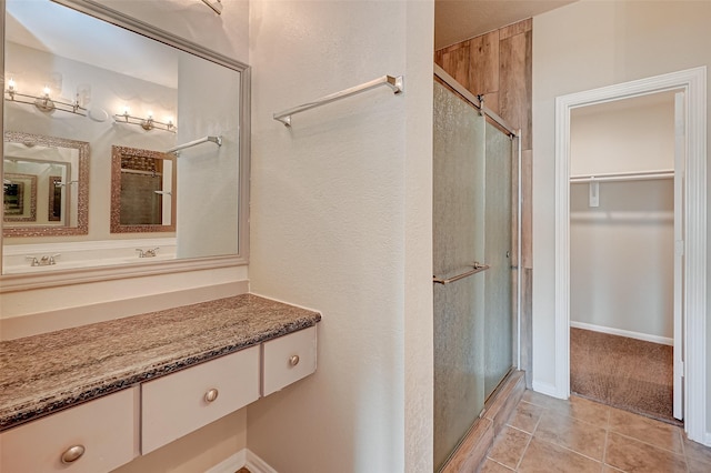 bathroom with tile patterned flooring, vanity, and an enclosed shower