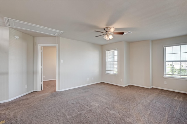 spare room with a wealth of natural light, ceiling fan, and carpet