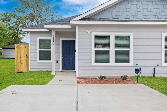 doorway to property featuring a yard