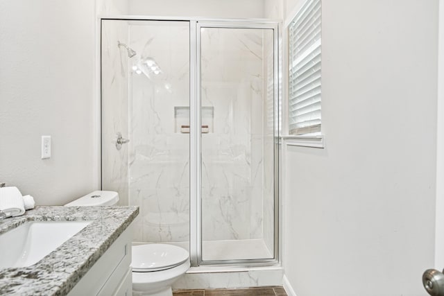 bathroom with vanity, toilet, and walk in shower