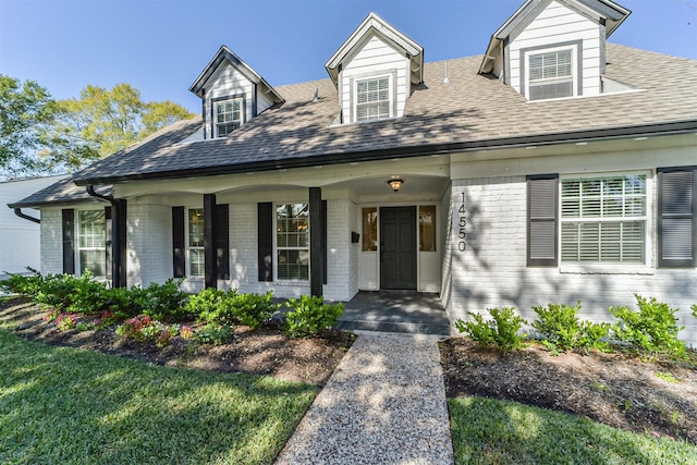 cape cod-style house featuring a porch