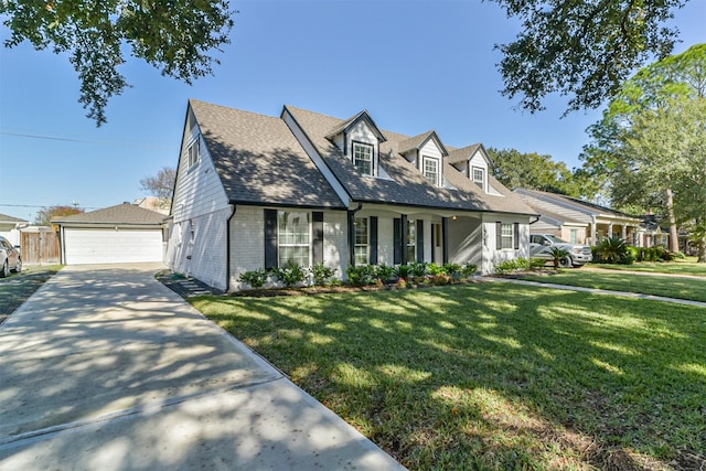 cape cod house featuring a front lawn, an outdoor structure, and a garage