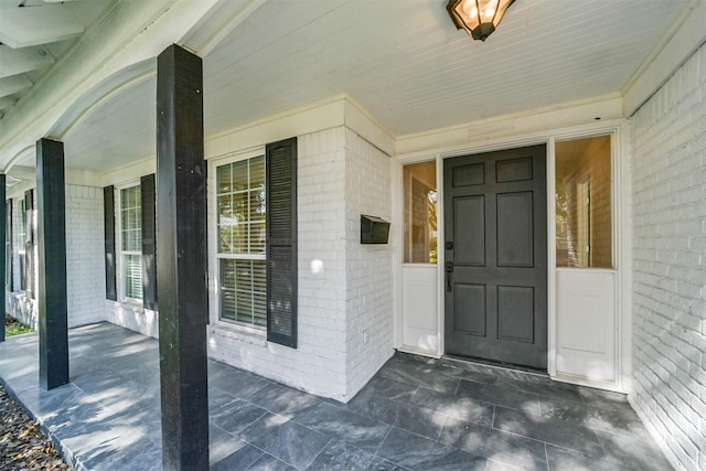 view of exterior entry with a porch