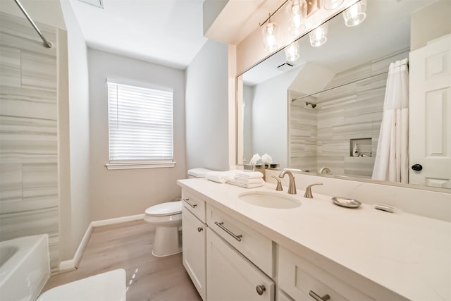 bathroom with hardwood / wood-style floors, vanity, and toilet