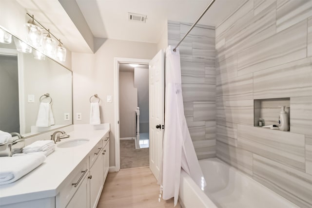 bathroom with vanity, wood-type flooring, and shower / tub combo with curtain