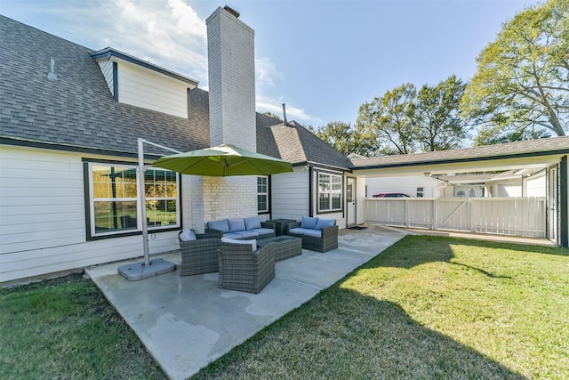 back of house with a lawn, an outdoor living space, and a patio area