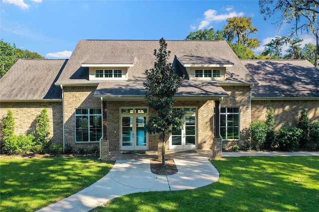 view of front of property featuring a front yard and french doors