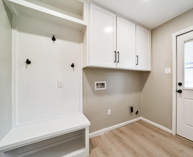 laundry area featuring electric dryer hookup, cabinets, washer hookup, and light hardwood / wood-style floors