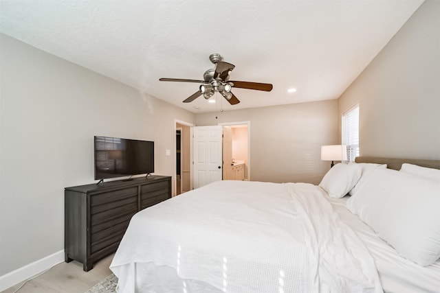 bedroom featuring ceiling fan and ensuite bath