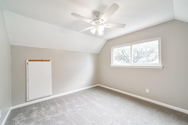 additional living space with ceiling fan, carpet, and lofted ceiling