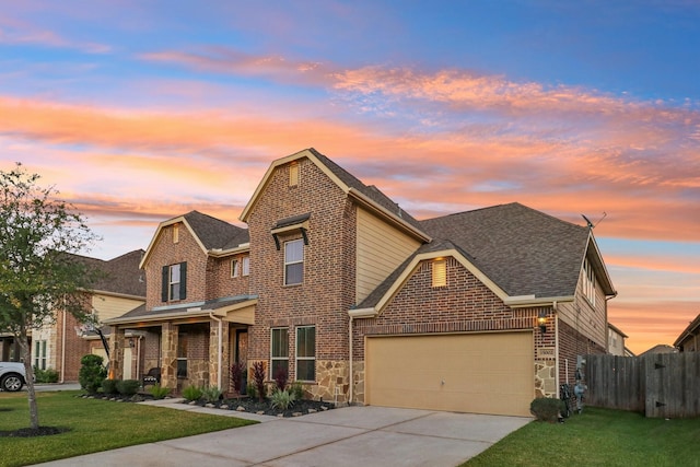 view of front of home featuring a lawn and a garage