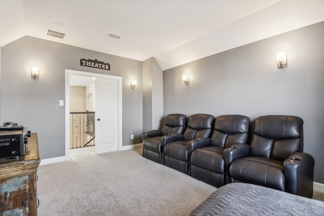 carpeted home theater featuring lofted ceiling