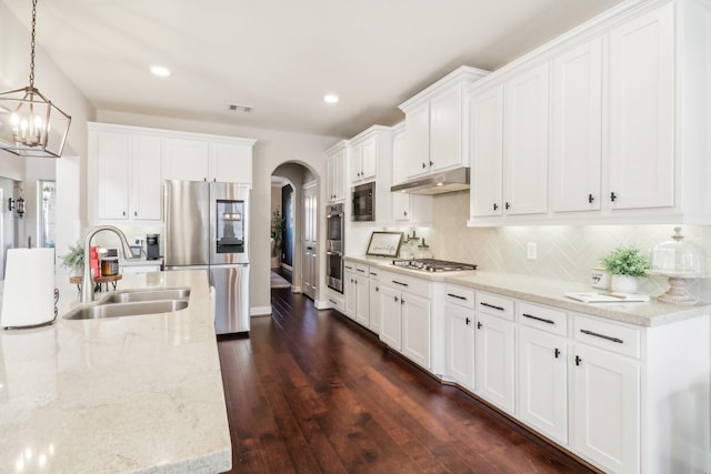 kitchen with white cabinetry, sink, stainless steel appliances, dark hardwood / wood-style floors, and pendant lighting