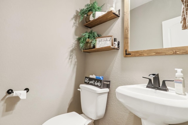 bathroom featuring toilet and sink