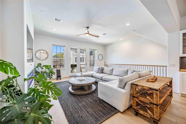 living room with ceiling fan and light hardwood / wood-style floors