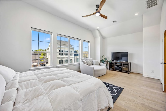 bedroom with vaulted ceiling, ceiling fan, and light hardwood / wood-style flooring