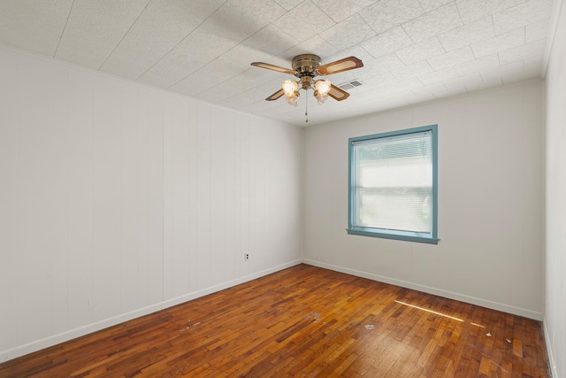 unfurnished room with ceiling fan and dark wood-type flooring