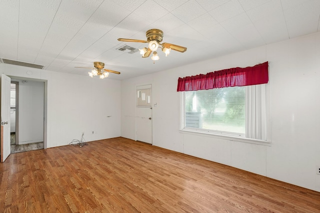 empty room with hardwood / wood-style floors and ceiling fan