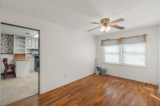 empty room featuring ceiling fan and hardwood / wood-style floors