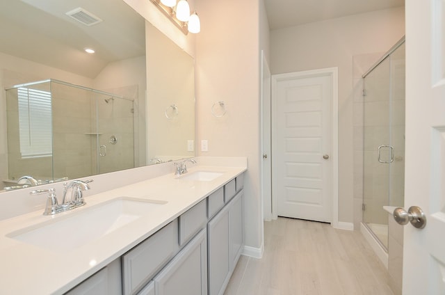 bathroom with wood-type flooring, vanity, an enclosed shower, and lofted ceiling