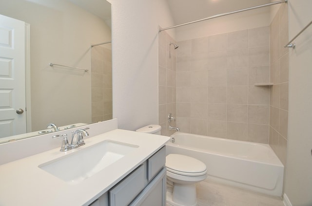 full bathroom with toilet, vanity, and tiled shower / bath