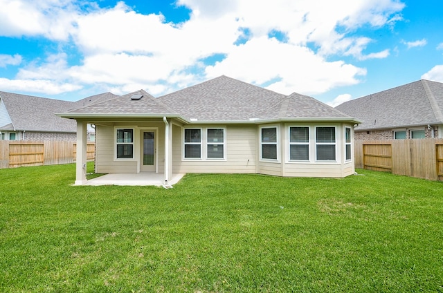 back of property with a lawn and a patio