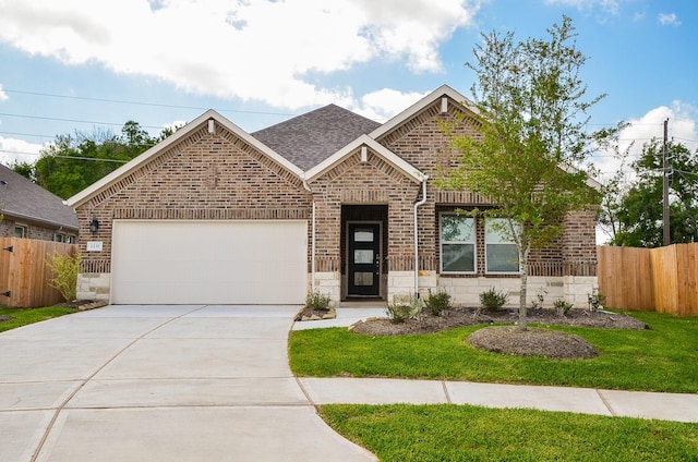 view of front of house featuring a front yard and a garage