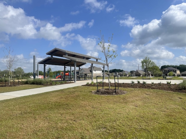 view of property's community featuring a playground and a lawn