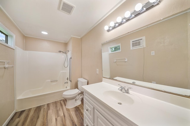 full bathroom featuring crown molding, wood-type flooring,  shower combination, toilet, and vanity