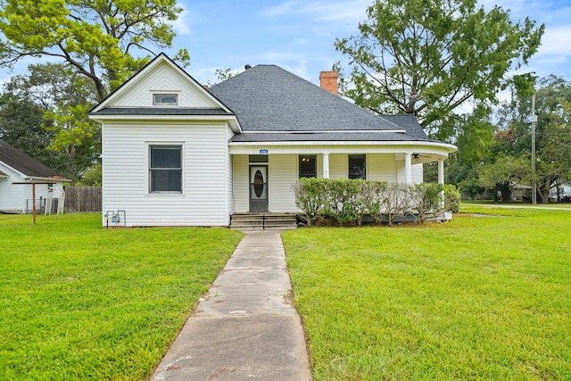 view of front of house with a front yard and a porch