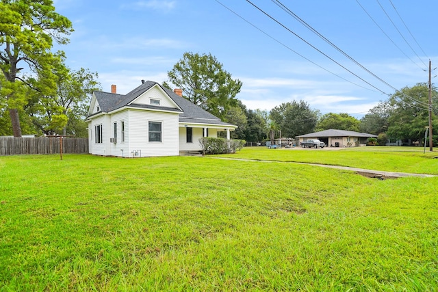 exterior space with covered porch and a yard